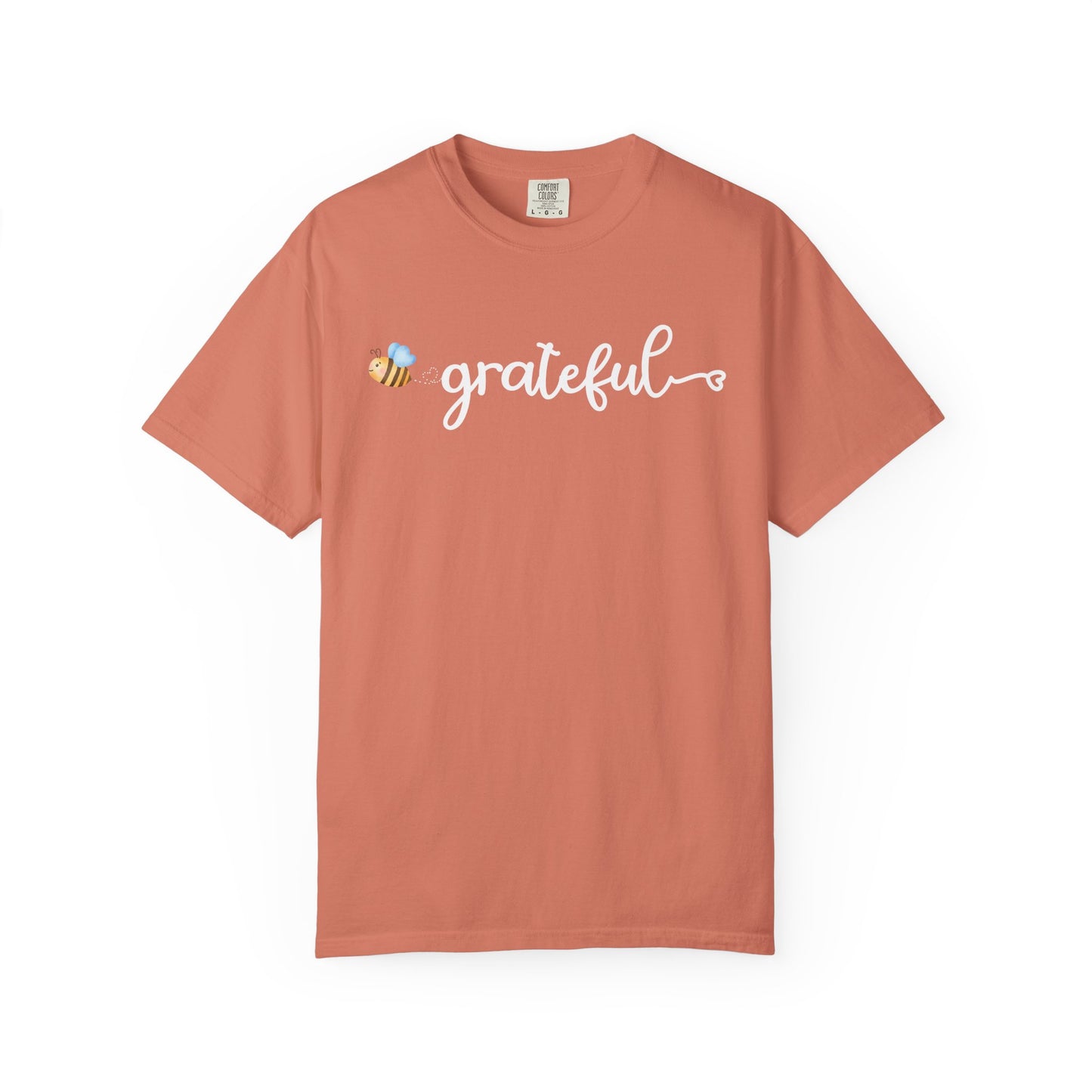 Coral t-shirt with 'grateful' text and bee graphic on a white background