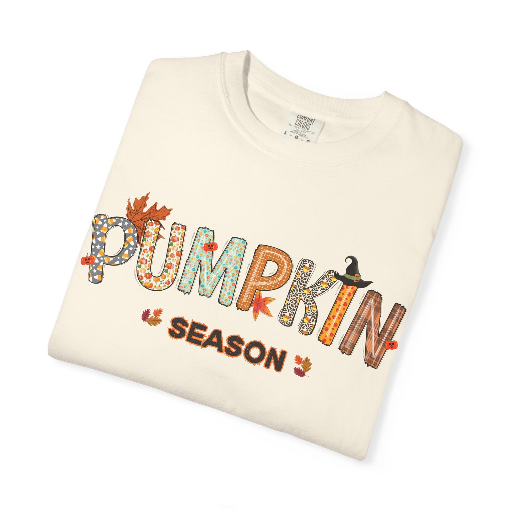 Folded cream-colored sweatshirt with 'Pumpkin Season' text and graphics on a white background