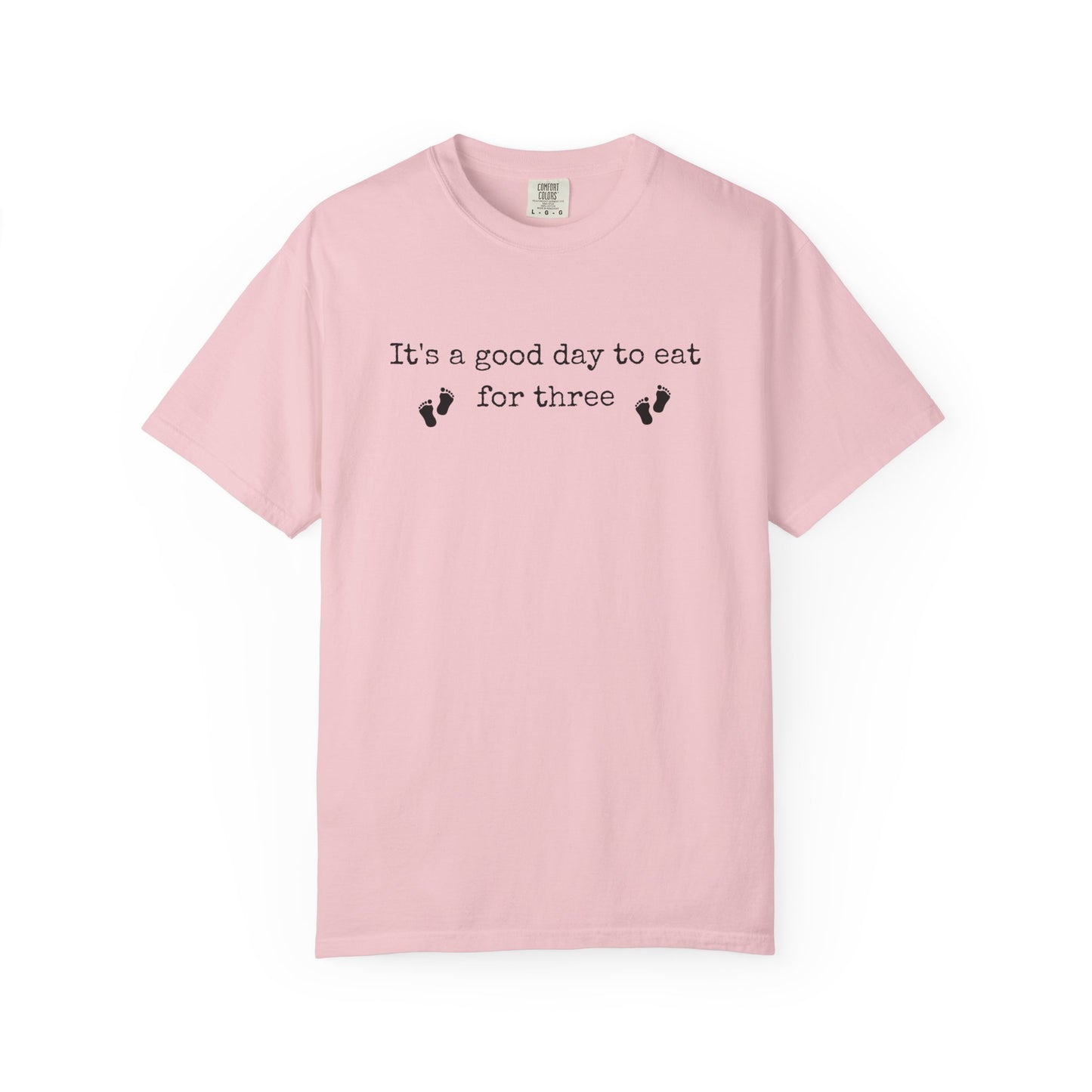 Pink t-shirt with text 'It's a good day to eat for three' on a white background