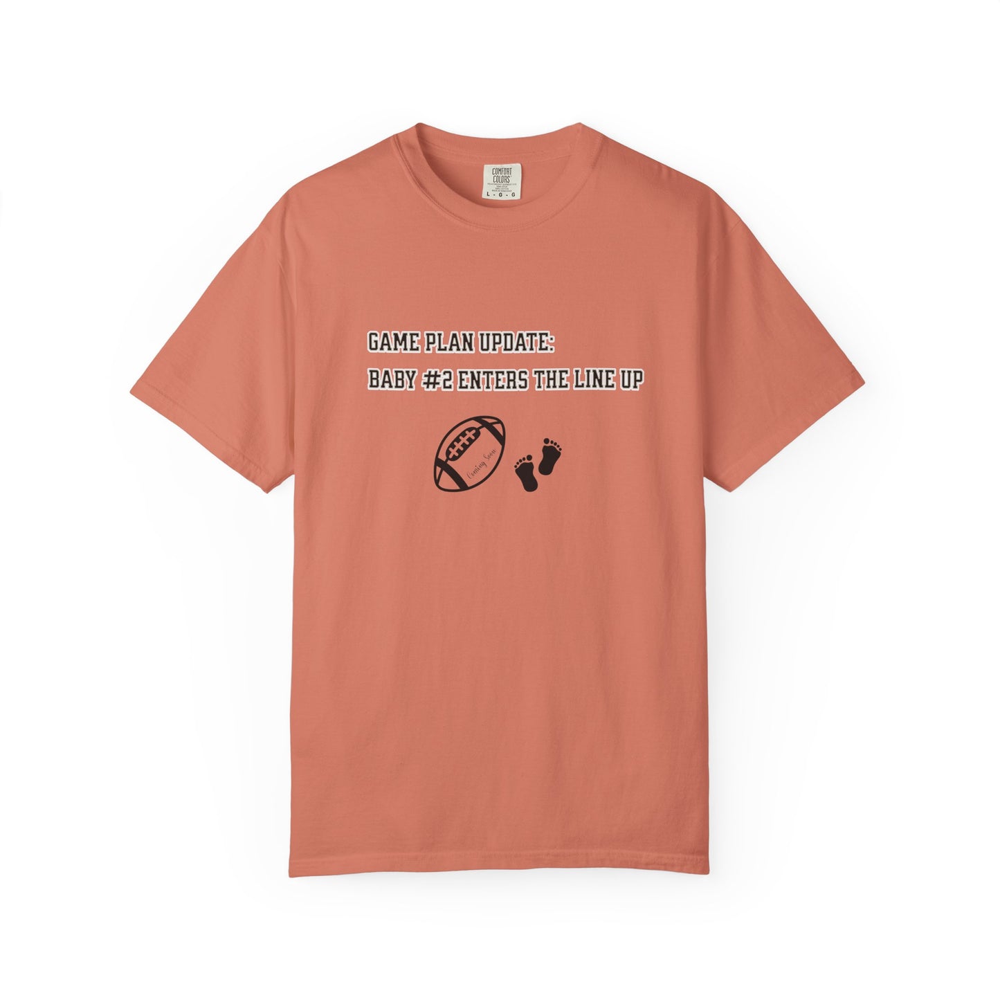 Coral t-shirt with text and graphics on a white background