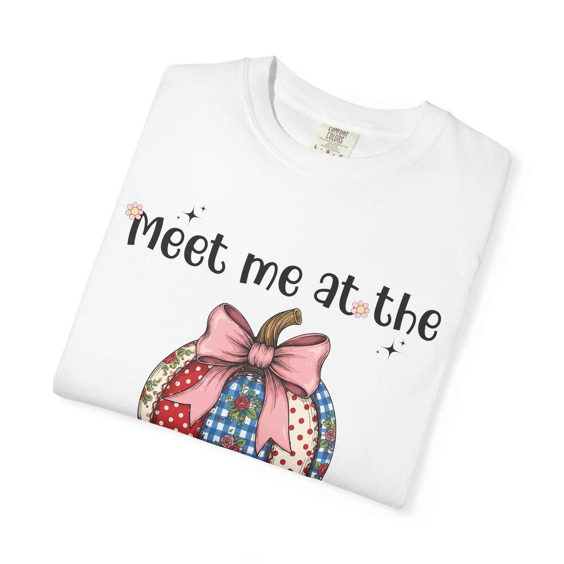 White t-shirt with colorful design and text 'Meet me at the' on a white background
