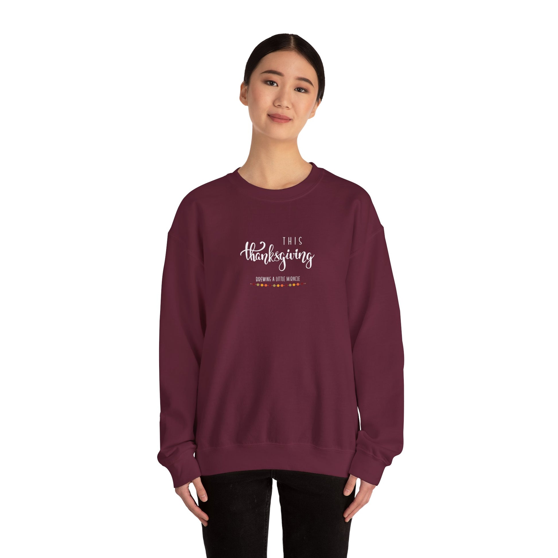 Maroon sweatshirt with text worn by a person on a white background