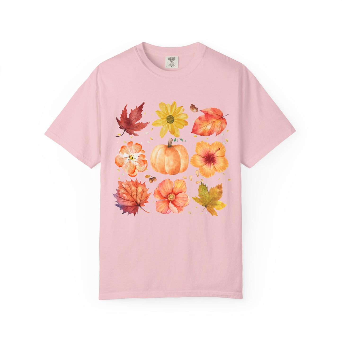 Pink t-shirt with autumn-themed design featuring leaves and pumpkins on a white background