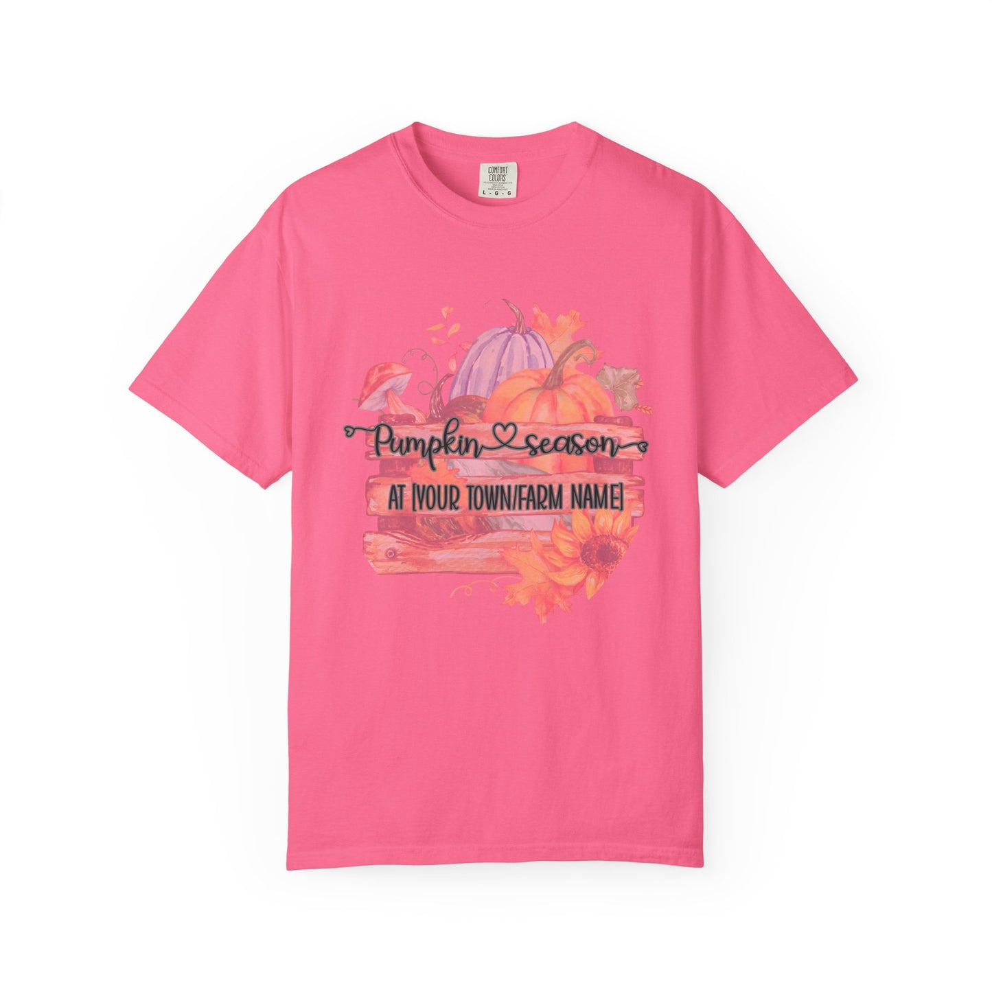 Pink t-shirt with pumpkin season graphic on a white background