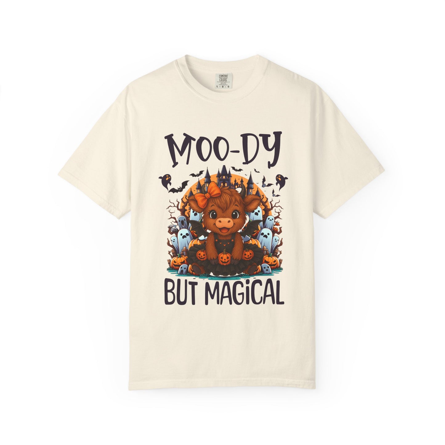 Beige t-shirt with a graphic of a moose and text 'Moo-dy But Magical' on a white background