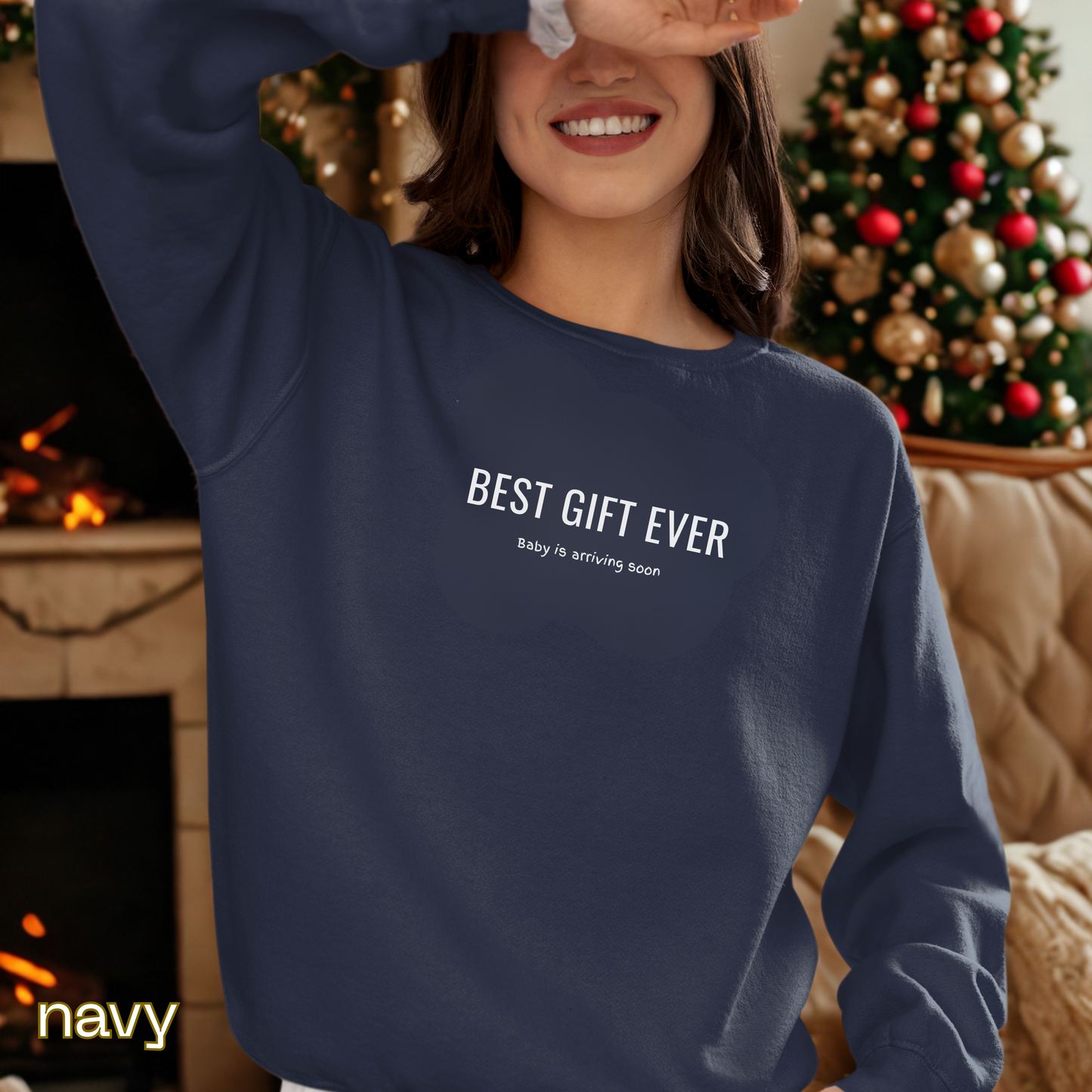 Person wearing a navy sweatshirt with 'BEST GIFT EVER' text in a festive setting.