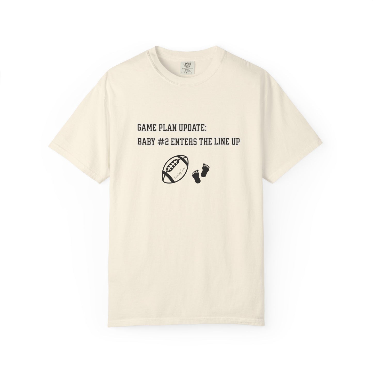 Beige t-shirt with black text and graphics on a white background