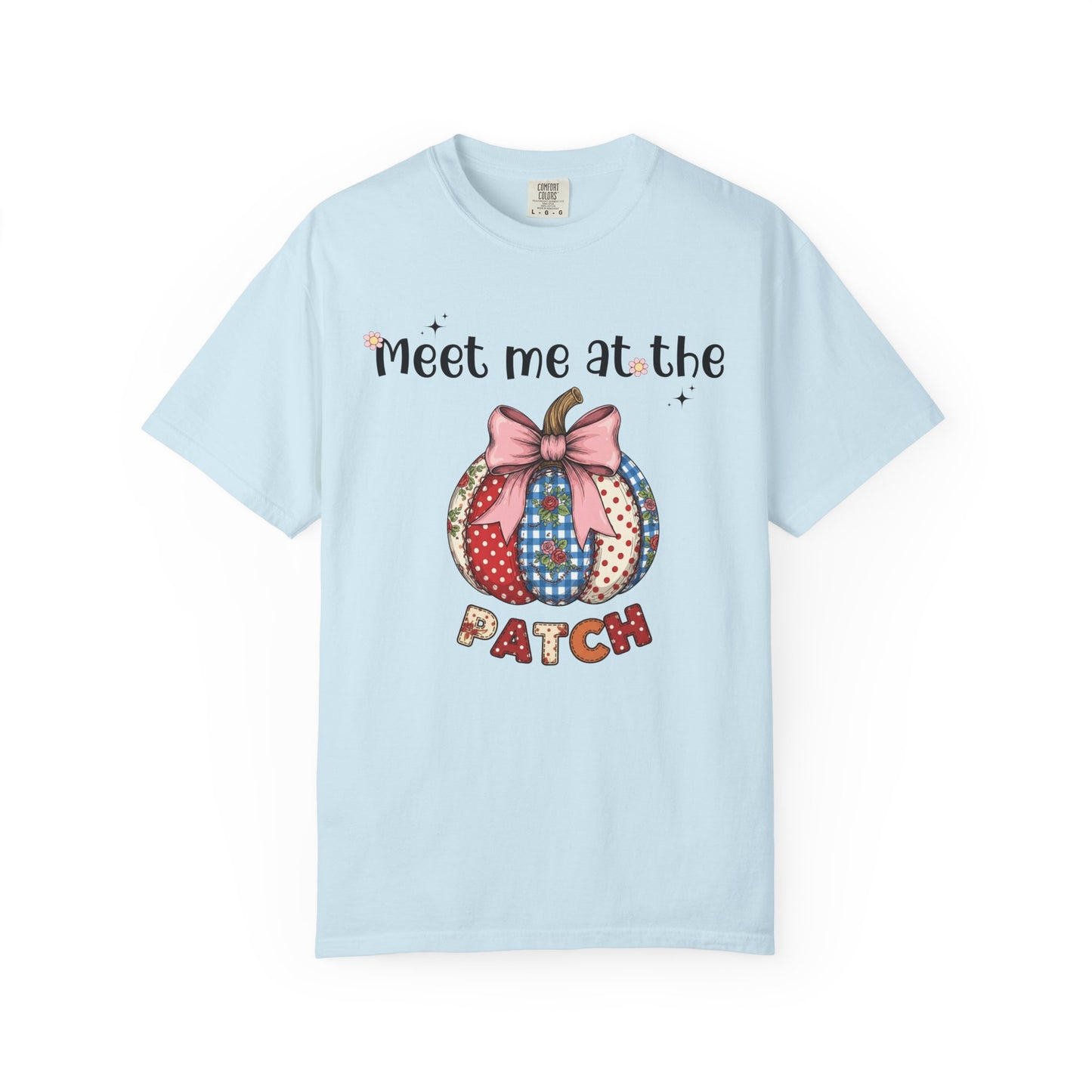 Light blue t-shirt with a colorful patchwork pumpkin design and text on a white background