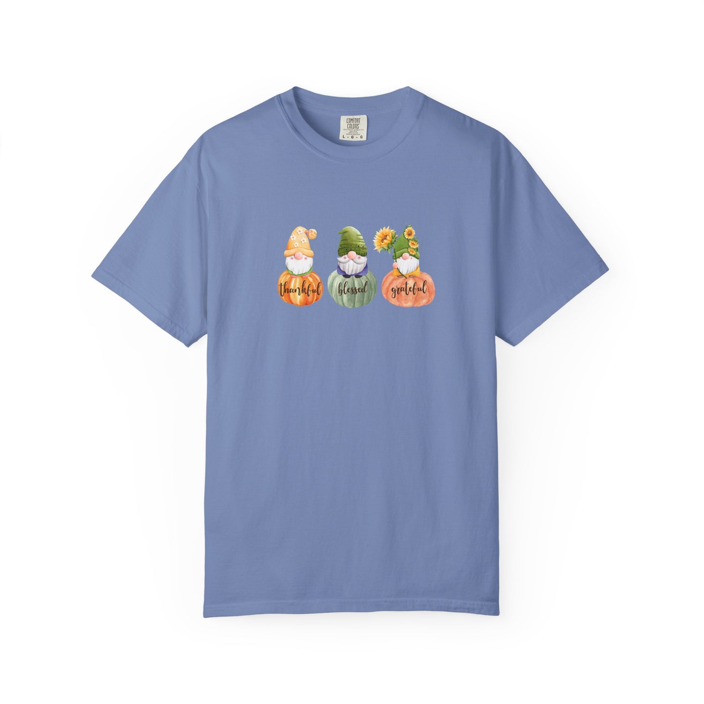 Blue t-shirt with three gnomes holding pumpkins and fall leaves on a white background