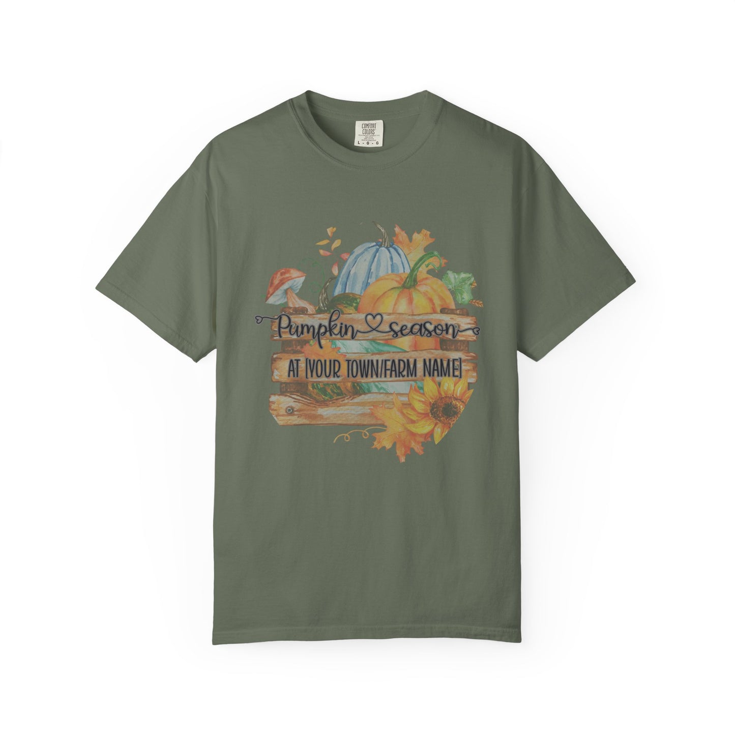 Green t-shirt with autumn-themed design featuring pumpkins and sunflowers on a white background