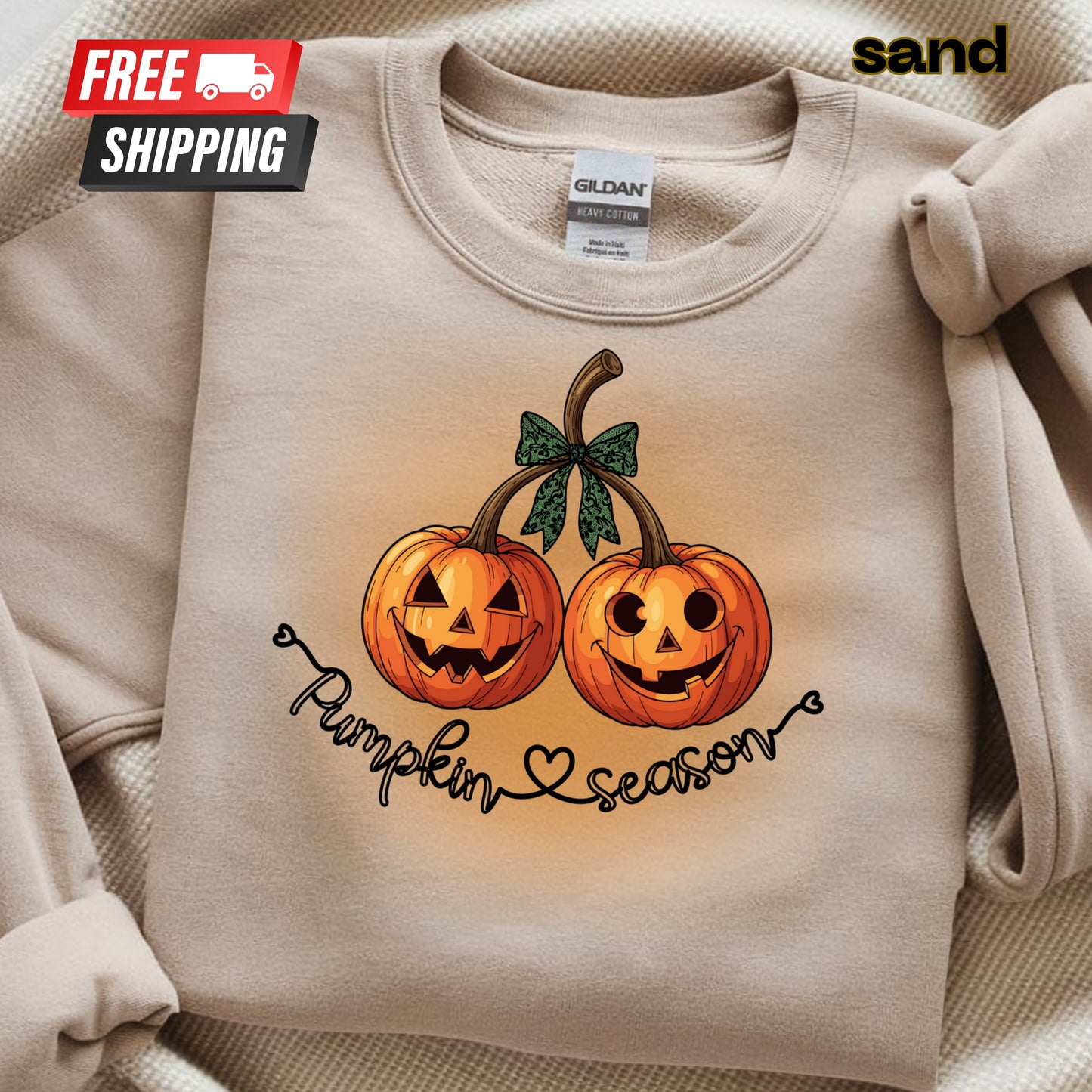 Beige sweatshirt with pumpkin design and 'Pumpkin Season' text, featuring a 'sand' brand label.