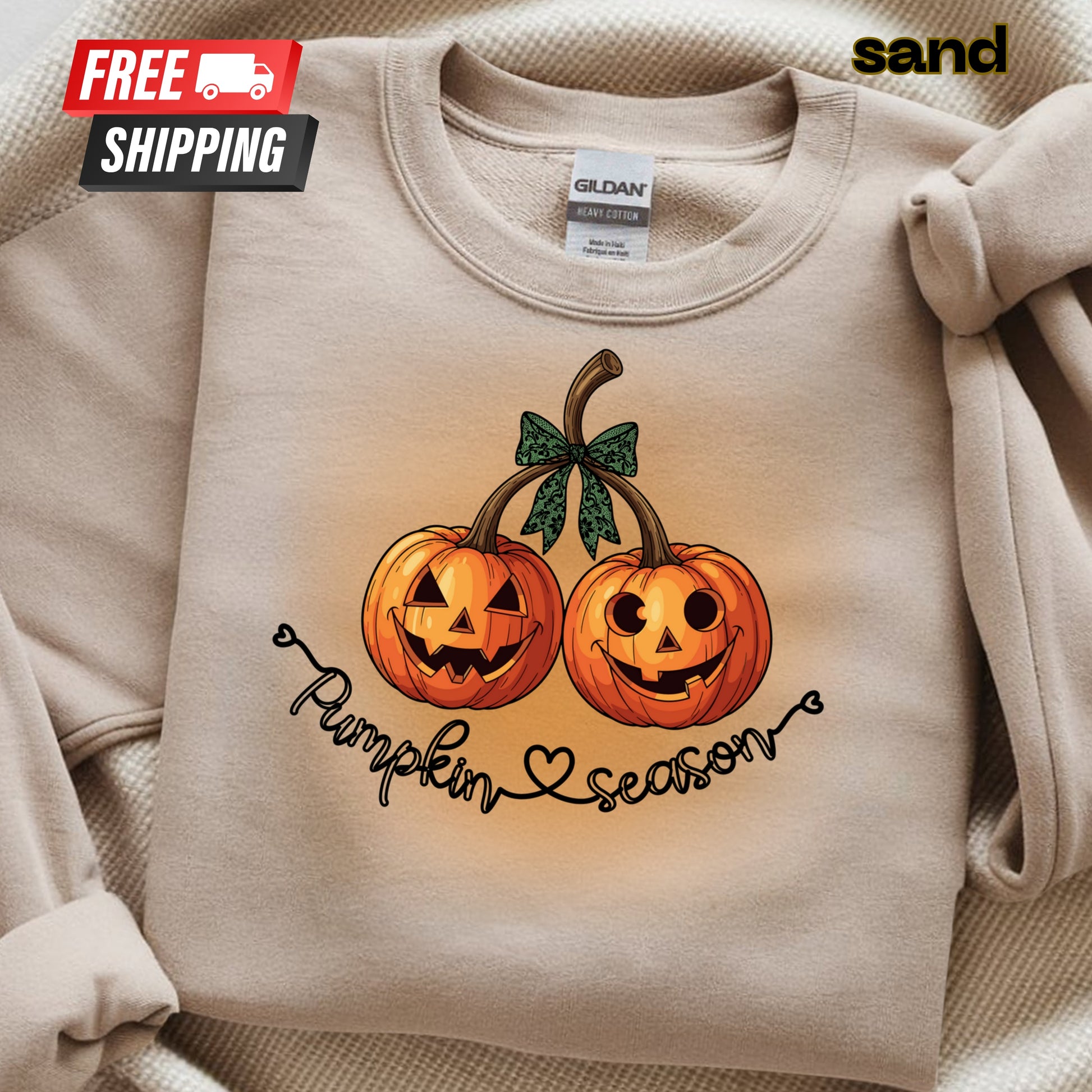 Beige sweatshirt with pumpkin design and 'Pumpkin Season' text, featuring a 'sand' brand label.