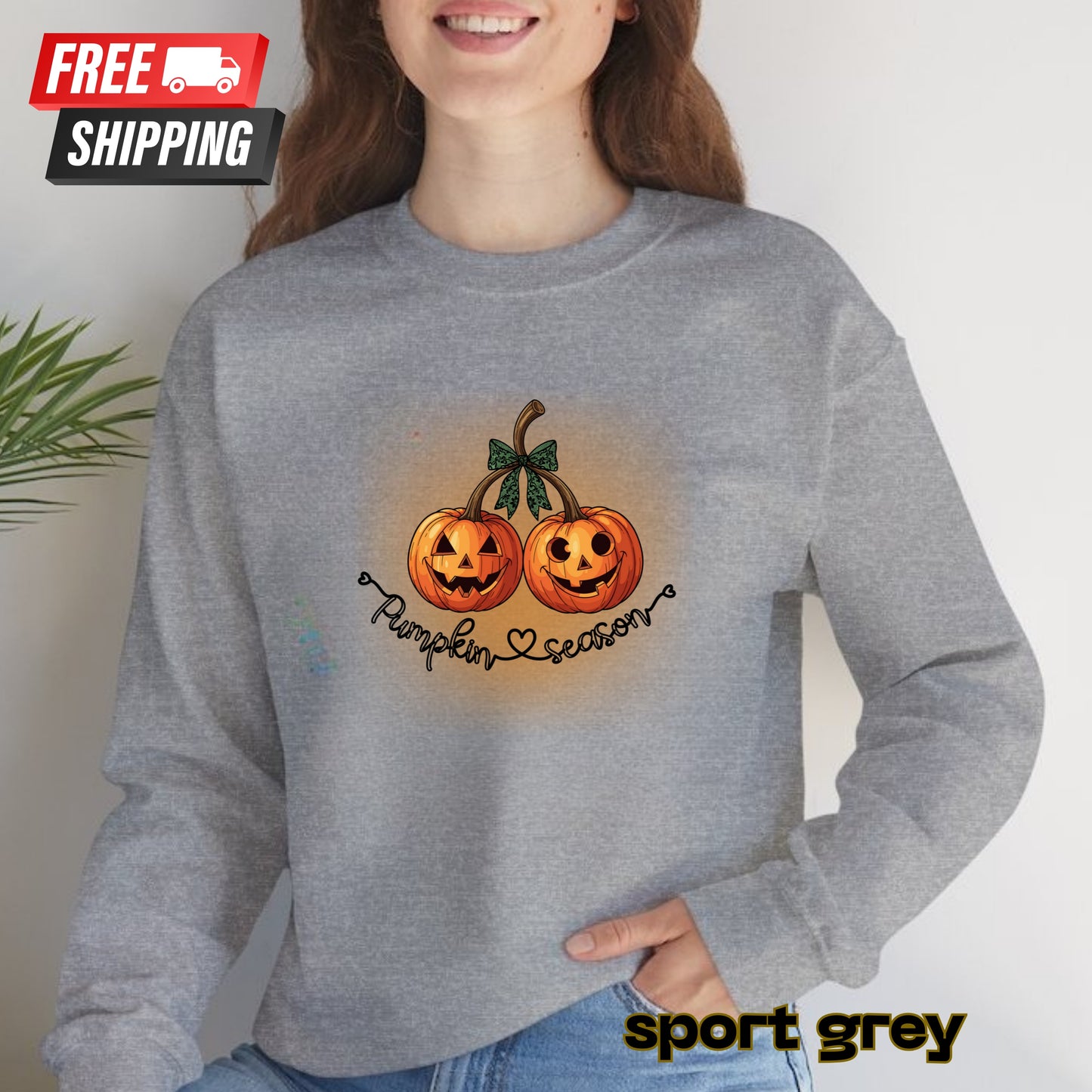 Person wearing a gray sweatshirt with pumpkin design and 'Pumpkin Season' text, with free shipping label.