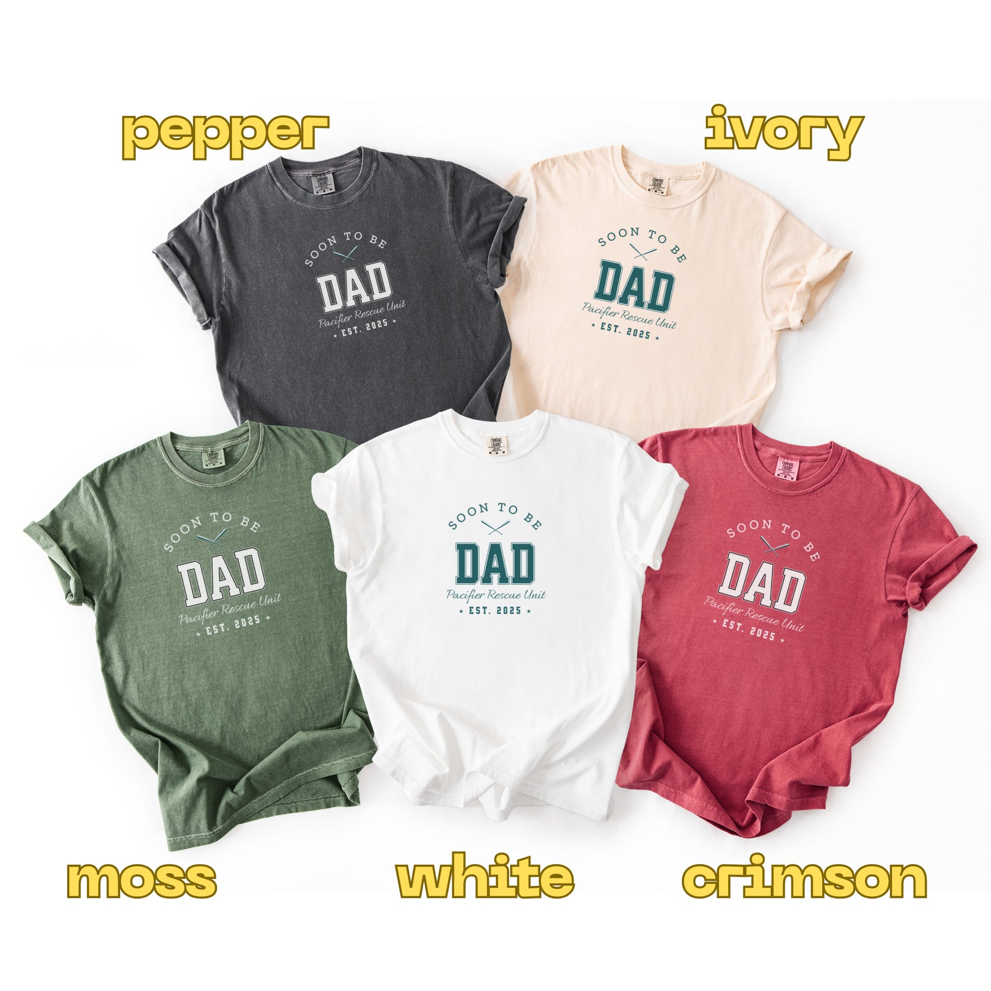 Five t-shirts in different colors with 'Soon to be Dad' text on a white background