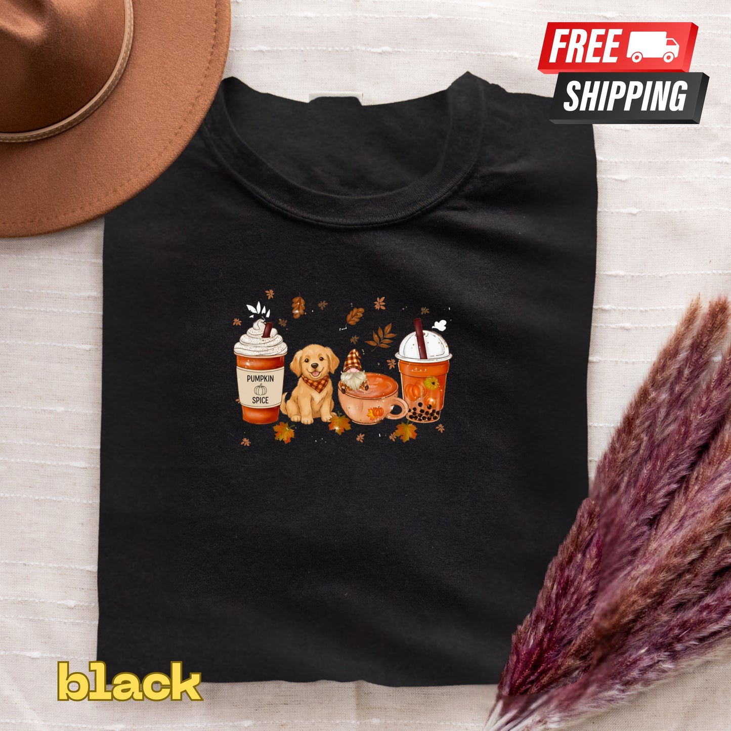 Black t-shirt with a graphic of a dog, pumpkin spice latte, and hot chocolate on a textured surface.