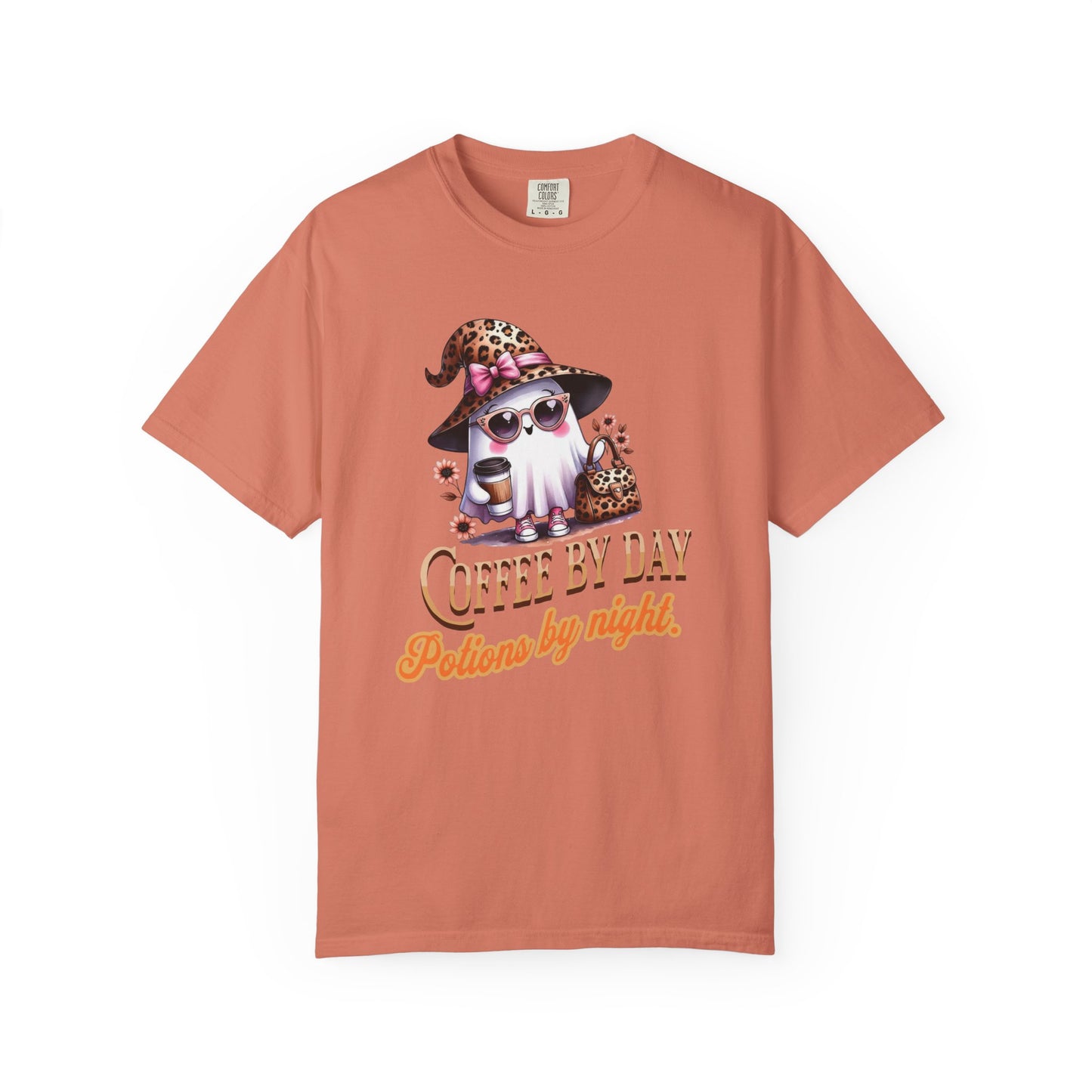 Coral t-shirt with a graphic of a gnome wearing a witch hat and sunglasses, with text 'Coffee by Day, Potions by Night' on a white background.
