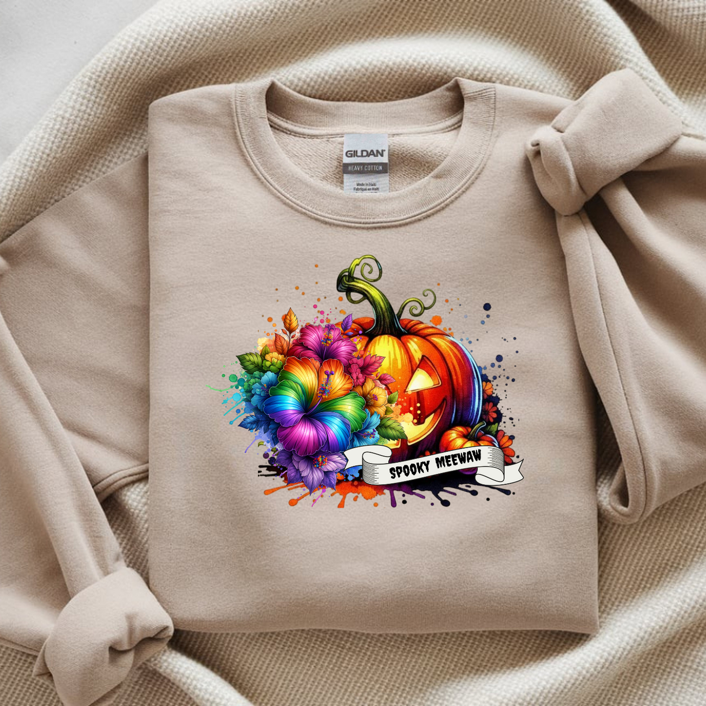 Beige sweatshirt with a colorful pumpkin design and 'Spooky Meow' text on a beige background