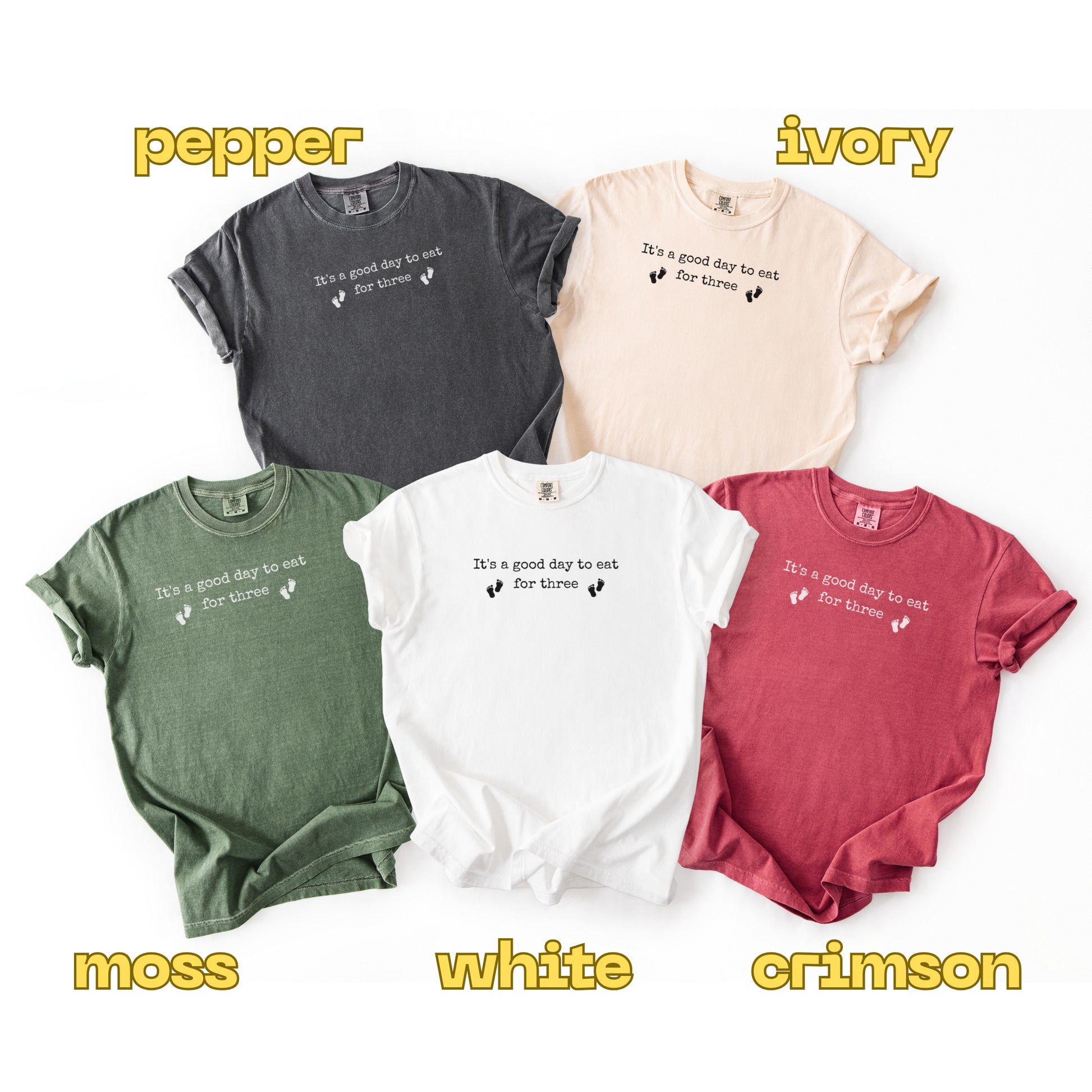Five t-shirts in different colors with text on a white background