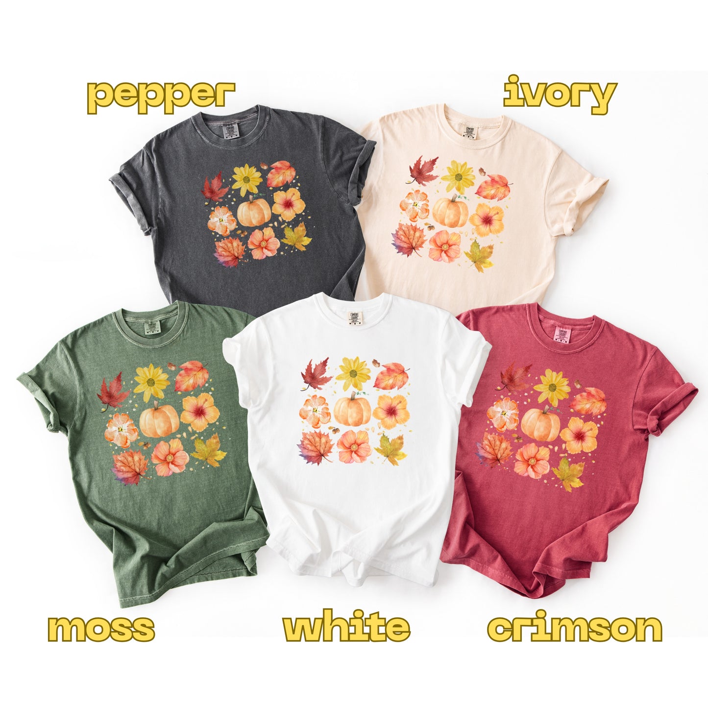 Five t-shirts in different colors with floral designs on a white background