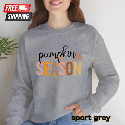 Person wearing a gray sweatshirt with 'pumpkin season' text, standing against a plain background.