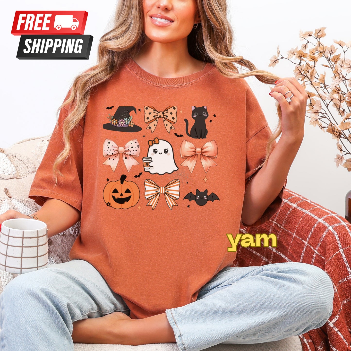 Person wearing a Halloween-themed orange t-shirt with graphics, sitting on a couch.