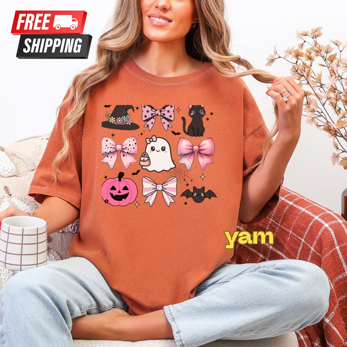 Person wearing a Halloween-themed orange t-shirt with graphics, sitting on a couch.