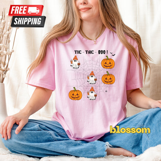 Person wearing a pink t-shirt with Halloween designs and 'blossom' branding.