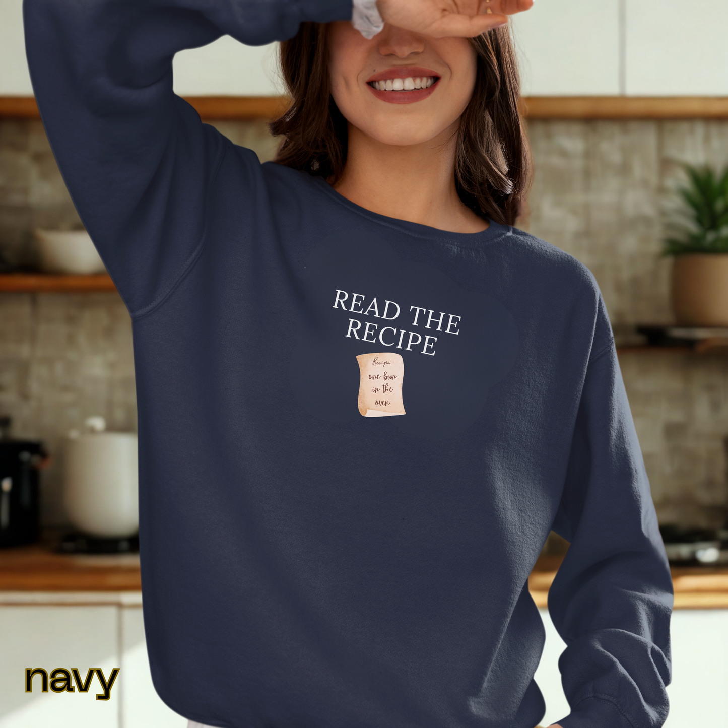 Person wearing a navy sweatshirt with 'Read the Recipe' text in a kitchen setting