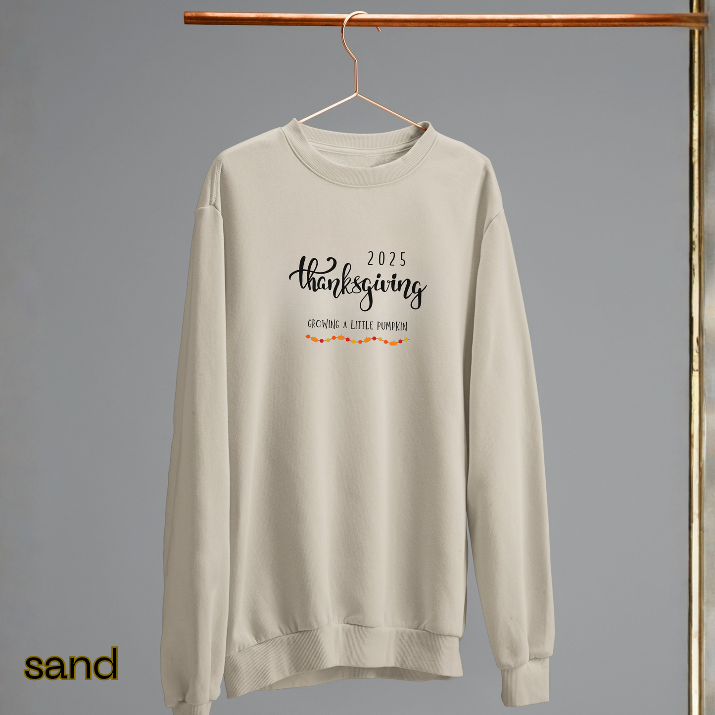 Beige sweatshirt with '2025 Thanksgiving Grandpa a Little Pumpkin' text on a gray background
