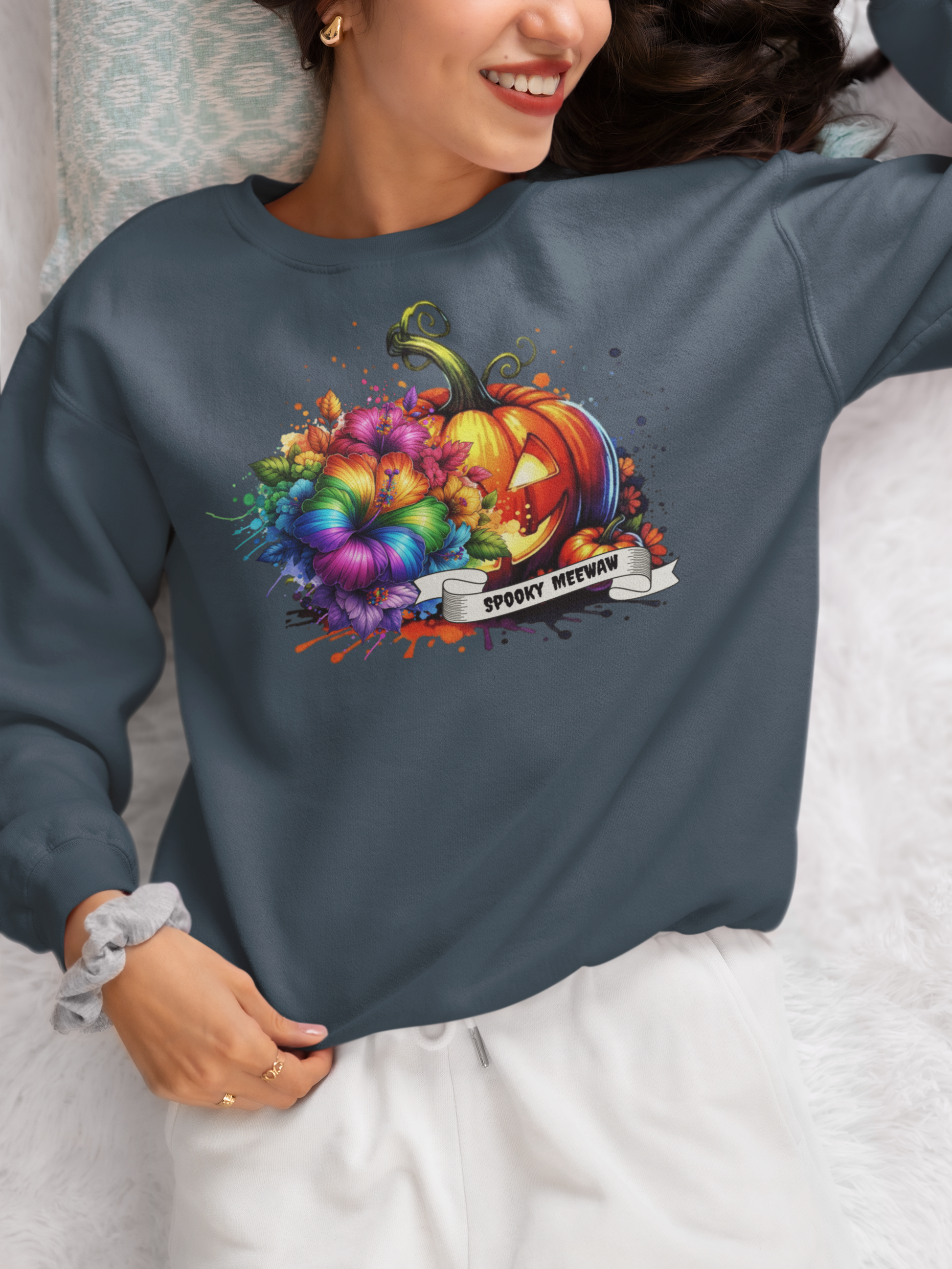 Person wearing a dark gray sweatshirt with a colorful Halloween design featuring pumpkins and text.