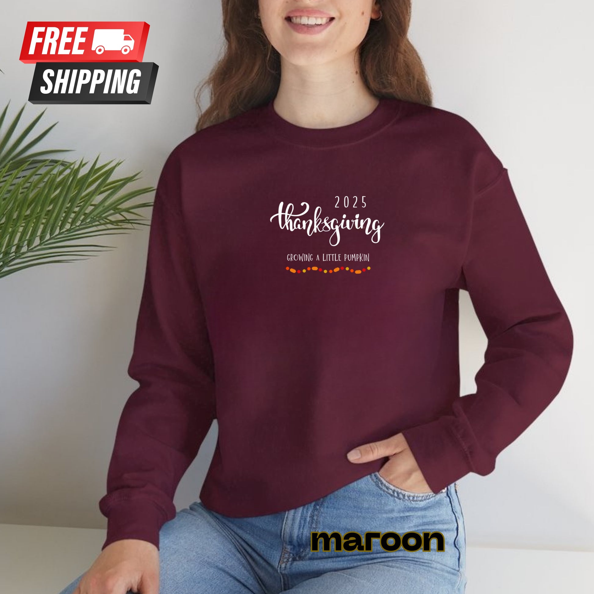 Person wearing a maroon sweatshirt with '2025 Thanksgiving' text, sitting against a white background.