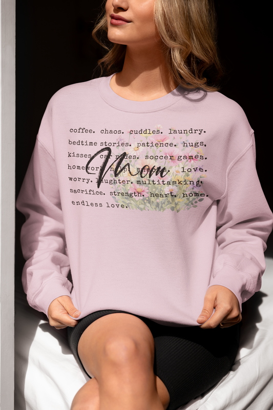 Person wearing a light purple sweatshirt with text and floral design.