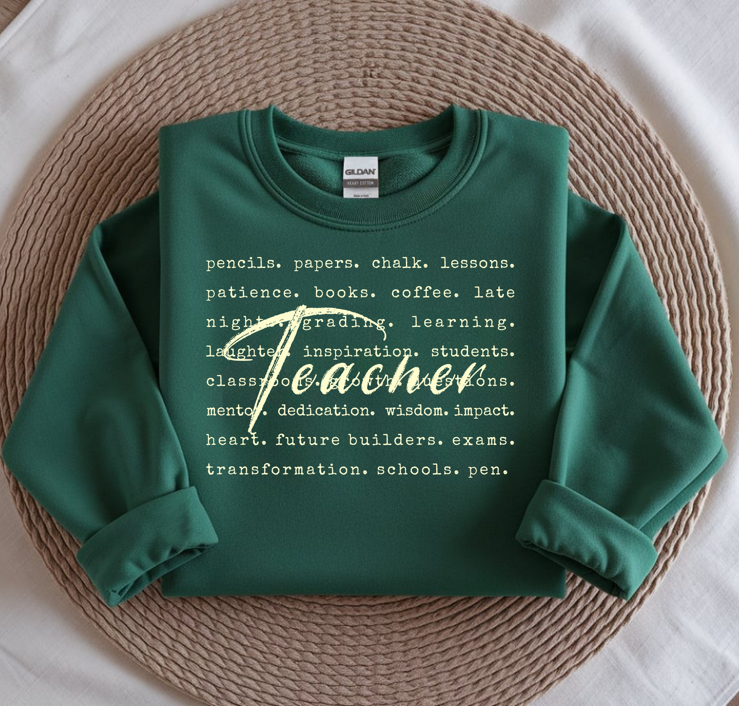 Green sweatshirt with text on a woven mat