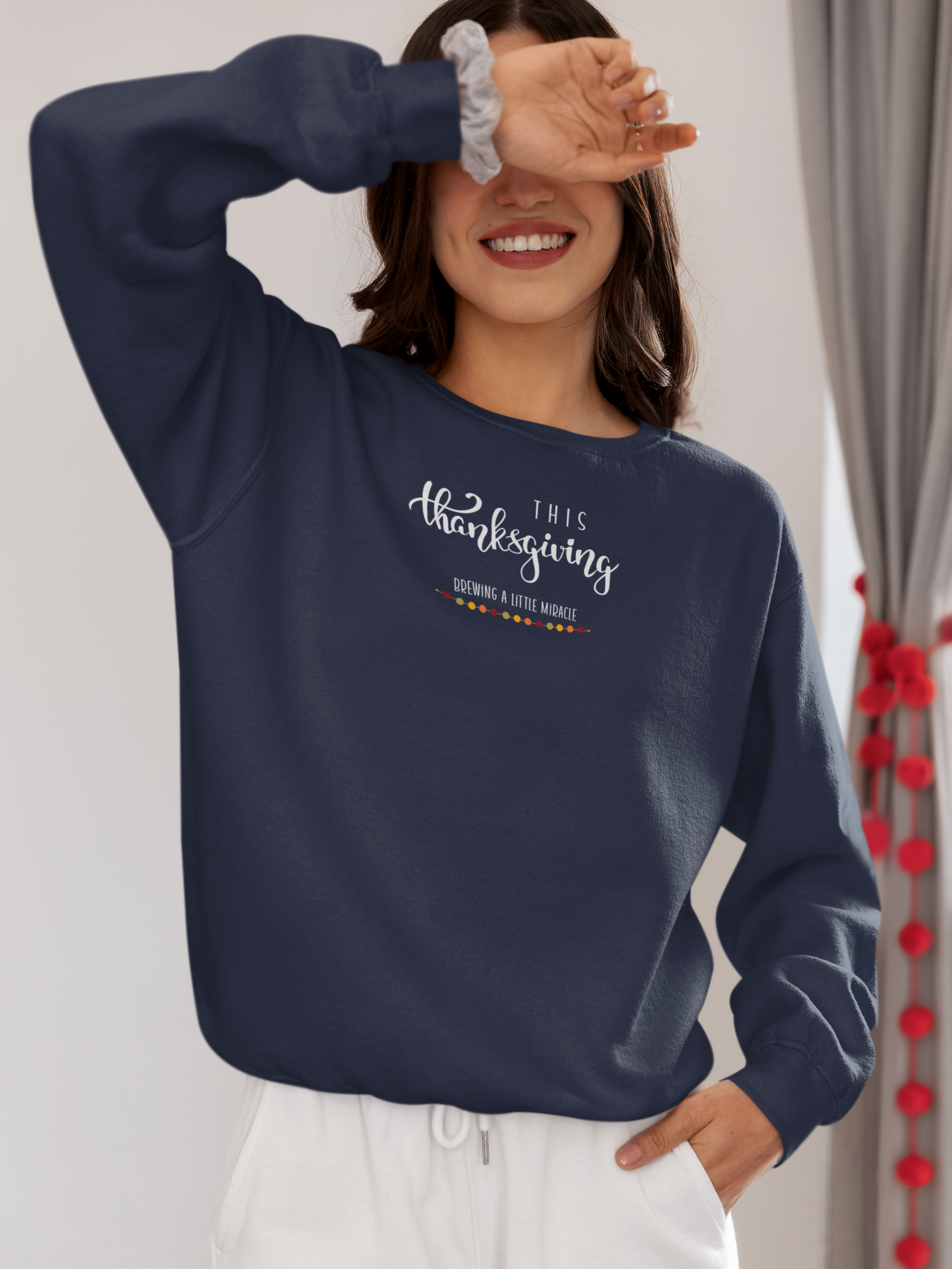 Person wearing a navy blue sweatshirt with text, standing against a neutral background.